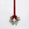 Close-up of Christmas wreath with pine needles, red berries, cones and velvet bow - Faux Snow Round Pine Needle Red Berry Pinecone Red Velvet Bow