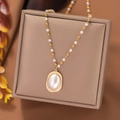 Elegant baroque pearl pendant necklace with gold beaded chain on jewelry display pad - Oval Bead (H1192) / Gold