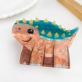 Niedliche Haarklammer im Dino-Design mit braunem Marmormuster und grünen Zacken - Ankylosaurus