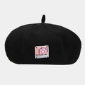 Detail of black beret with pink floral applique and decorative patch text embroidery - One Size / Black