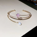 Macro detail of gold flower bracelet featuring pink stones, white pearl and zircon pave - Gold-Pink Flower (HB4656)