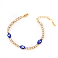 Golden titanium steel bracelet featuring blue evil eyes and clear cubic zirconia charms - Oval