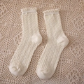 Mid-calf cable knit socks in creamy white featuring delicate ruffle edges and soft texture - Crew Socks / Milk White