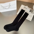 Classic black ribbed calf socks with elastic cuffs and minimalist vertical knit pattern - One Size / Black