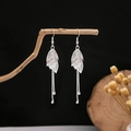 Silver long tassel earrings with hollow leaf design hanging on a natural wooden branch - Silver Hollow Leaf Fine Chain Tassel Style (E4595-6)