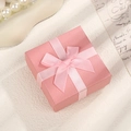 Elegant pink textured jewelry box with a satin bow, perfect for rings and necklaces - Pink