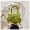Macro detail of vibrant green leather mini bag with a sparkling rhinestone bow - Light Green