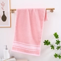 Pink cotton hand towel with white herringbone texture hanging on a wooden rod - Pink Large Arrow Pattern
