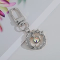 Silver metal keychain with feather pendant featuring sparkling crystals and blue eye detail - Silver Feather