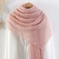 Pink crinkled cotton linen scarf with raw edges displayed on a wooden hanger - Pink