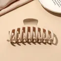 Detail of matte beige large hair claw clip with multi-tooth design on a fabric background - Beige Matte-Keel