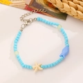 Bracciale estivo con perline celeste e graziosi ciondoli a forma di pesce e stella marina - Pesce Blu Cielo Oro KC (27 Oro KC 7249)