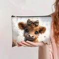 Toiletry bag featuring highland cow print with leopard bow, handheld for size reference - Highland Cow with Leopard Bow (jiayingpbb0102)