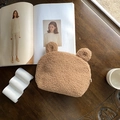 Brown teddy fleece bear shaped shell makeup bag with cute ears on a wooden desk - Tan