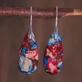 Macro shot of boho style teardrop earrings with colorful stone textures on a branch - Red Blue Cream Abstract Stone Style (ER1025-9)