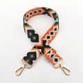 Close-up of geometric jacquard embroidery strap with adjustable light gold metal hardware - Dark Blue Green Orange