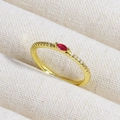 Macro view of a gold ring featuring a red oval gemstone and white side zircon stones - Red Oval Marquise Stone (款式9)