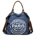 Blue canvas tote bag with brown straps and white Paris themed graphic print - Blue