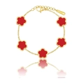 Close-up of golden stainless steel bracelet featuring five red clover-shaped pendants - Gold Red