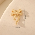 Macro view of gold bow pendant with zircon inlay showing 1.9x2.0cm dimensions - Ribbon Flow Style MYYX00636 / Gold