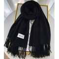 Detail of soft black cashmere scarf with fringed edges and branded Gerunsi tag - Black