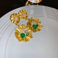 Golden flower earrings with pearls and green accents on a white porcelain dish - Gold Pleated Floral Green Bead Style (45#)