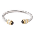 Macro detail of silver cable twist bangle with gold accents and black onyx stone tips - Gold & Silver - Black Agate