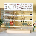 4-tier white metal earring organizer with a solid wooden base for jewelry storage - 144 Holes White