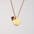Close-up of gold mirror-finish round pendant with a red birthstone on a delicate chain - 1# Birthstone