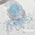 Macro shot of mixed size blue mermaid aurora glass nail art beads in a clear storage jar - Mocha Light Blue