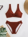 Detailed view of terracotta crinkle fabric bikini set with knot front and summer accessories - Brick Red