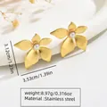 Gold stainless steel flower earrings with white pearl center on white ceramic bowl - Stainless Steel Pearl Flower Hoop