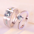 Detailed view of silver S925 couple rings with cubic zirconia on pink fabric - Ten Out of Ten