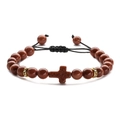 Macro detail of brown goldstone cross bracelet with sparkling beads and black braided cord - Gold Sandstone