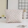 Detailed close-up of a floral quilted makeup bag with pink flower patterns and cotton texture - Large Capacity / Pink Floral