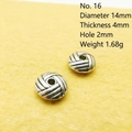 Detailed view of woven texture silver spacer beads measuring 14mm with 2mm hole - 16#