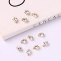 Flat lay of gold round charms with sparkling cubic zirconia on a white background - Simple Zircon Inlaid Small 6mm