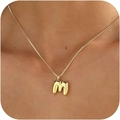 Minimalist gold necklace with a polished letter M pendant shown on a model - Gold M