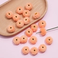 Detail showing 20mm soft coral faux rabbit fur pompom beads with metal center hole - Orange
