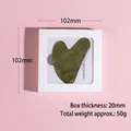 Dark green heart-shaped jade scraping board in a white square gift box with pink background - Heart Scraper + Box