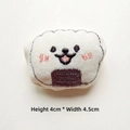 Detail showing plush onigiri accessory with embroidery measuring 4cm high by 4.5cm wide - Onigiri Rice Ball