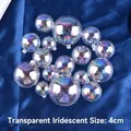 Close-up of 4cm iridescent colorful cake topper spheres on a deep blue silk background - 4cm / Transparent Iridescent