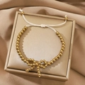 Gold beaded bracelet with bow pendant featuring an adjustable white drawstring closure - Gold Bead Bow Bolo Bracelet (N-1109)