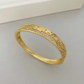 Macro shot of gold bracelet featuring wavy patterns of micro-set sparkling white zircons - Gold (White Rhinestone)