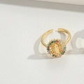 Detail of gold bow ring featuring embossed center and colorful gemstone accents - Multicolor Zirconia