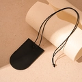Detail view of the black leather texture and fine stitching on the neck pendant key case - Black