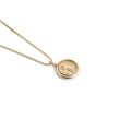 Macro detail of a gold-plated necklace featuring a round pendant with embossed figure - Religious Relief Figure-C0262CX