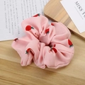 Pink fabric scrunchie with strawberry pattern on a warm wooden background - Pink Strawberry