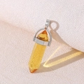 Polished citrine hexagonal crystal pendant with silver metal bail on neutral background - Citrine
