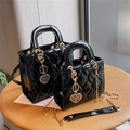 Glossy black patent leather quilted handbag with gold chain and heart pendant detail - Small / Black